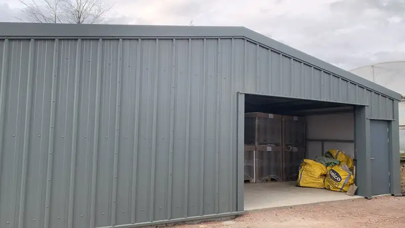 Steel storage building with roller shutter door and personnel door